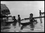 Children in canoes, Manus Island, Papua New Guinea