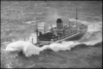 Aerial view of the fire damaged ship Gothic, in rough sea, Cape Palliser area, South Wairarapa