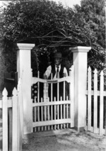 Henry Stevenson standing at the gateway of the Pompallier House, Russell