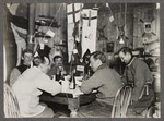 Group of men sitting around a table in a hut, Antarctica - Photograph taken by G Murray Levick
