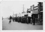 Crowd of unemployed demonstrators standing on a street in Palmerston North