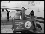Air hostess Miss J Stanich by the TEAL Solent flying boat Awatere, Evans Bay, Wellington