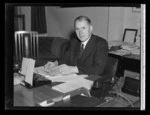 Portrait of the Honourable F Jones, sitting at a desk