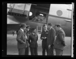 J Gamble, left, Squadron Leader Dick, third from left, and Squadron Leader HG Hazelden, second from right, with unidentified Royal New Zealand Air Force personnel, alongside Handley Page Hastings airplane, location unidentified