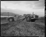 Earthmoving machinery being used to form an area by Wellington Airport at Rongotai - Photograph taken by T Ransfield