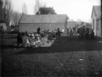 Group of people having a meal at a hui on a unidentified marae