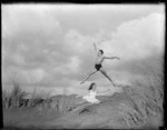 Poul Gnatt and Julie Barker on sand dunes at Bethells Beach