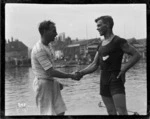 Single scullers shaking hands at the Royal Henley Peace Regatta, England