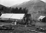 Group outside a dwelling in Otira Gorge