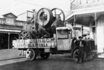 White truck of P W Allen & Company carrying a stationary engine