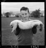 Duncan Adair holds an albino opossum