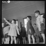 Children performing an action song at Te Kaha Native School, Bay of Plenty