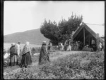 Scene at a meeting house in Tokaanu, Taupo district, with tohunga