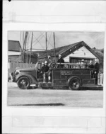 Firemen on a Upper Hutt Fire Brigade fire engine