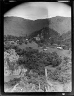 View of farmhouse, farm buildings and hills, Mangamahu