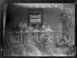 Group of people on a verandah, Mangamahu