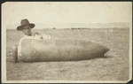 World War I soldier beside a 'dud' missile