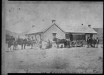 Men and horses and a wagon outside Otematata Hotel