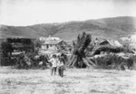 Reverend George McNeur and a Chinese man, alongside dwellings at Waikaia