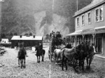 Richard John Seddon on horseback, and a carriage of people, including Mrs and Miss Seddon, outside the Terminus Hotel, Otira