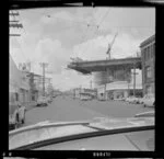 Construction of southern motorway viaduct, Newmarket, Auckland, with Spinks Garage Ltdon the corner of Clovernook Road