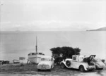 Boats, cars and a tow truck, alongside Lake Taupo