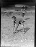 Māori boy with a rugby ball, Waikato