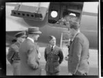 John Gamble, left, Wing Commander Dick, centre, and Squadron Leader HG Hazelden, with unidentified Royal New Zealand Air Force personnel, alongside Handley Page Hastings airplane, location unidentified