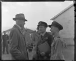 Sir Keith Park chatting to Wing Commander E W Tacon and Air Commodore E H Fielden, King's flight, Whenuapai Air Base, Waitakere City, Auckland