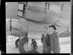 Mr Roper and Mr Cranston, Flight Engineer, both from Tasman Empire Airways Limited, inspecting Handley Page Hastings airplane, Royal New Zealand Air Force station, Whenuapai, Waitakere City