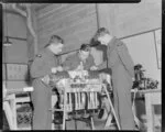 Sergeant W L Curry instructs AC2 R C Matheson and AC2 Humphries on a Gipsy Major engine, Hobsonville Technical Training School