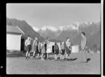 Teacher and pupils standing outside Weheka School, Fox Glacier, West Coast Region