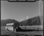 New Zealand Railways Road Services bus, with Fox Glacier in background, Weheka, Westland District