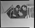 Flight Lieutenant O'Donnell in cockpit, giving training to cadets N S Fraser and N M White, how to operate a Harvard aircraft, Wigram, Christchurch