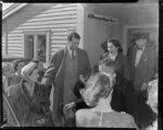 Sir Laurence Olivier and Vivien Leigh (Lady Olivier) surrounded by a crowd on arriving with Old Vic Theatre Company at Whenuapai Royal New Zealand Air Force base on an Australian National Airways flight