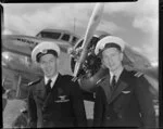 Pilots - Commander K Fitten as co-pilot and pilot Tom Mounsey in front of ZK-AFD Electra, Kuaka, opening day of the New Zealand National Airways Corporation, Rotorua