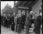 Maori elders welcoming Sir Peter Buck at Marae by giving nose to nose greeting, Ngaruawahia, Waikato