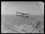 De Havilland Dragon biplane, East Coast Airways flying over Napier, Royal New Zealand Air Force air sales