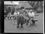 One of the performers pouring [kava?] into a bowl for a guest while the others look on, meke, Lautoka, Fiji