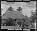 Fijian bure with a group of men preparing kava in front, at the meke, Lautoka, Fiji