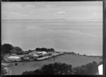 Coastal view from Takapuna, North Shore City, Auckland, featuring Takapuna Grammar School grounds, a single storied house with a tennis court [headmaster's residence?] and Waitemata Harbour