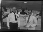 Captain Hampshire and Neil Geikie (left to right) stand abrest to the underside of a Qantas Empire Airways Douglas DC-4 (VH-EBK) Skymasker aircraft Kai-Tak Airport, Kowloon, Hong Kong