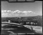 Unidentified men and woman looking out over Auckland City from One Tree Hill