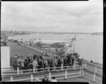 Passengers waiting to board the Tasman Empire Airways Ltd Solent seaplane Aotearoa II ZK-AML, Mechanics Bay, Auckland