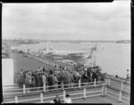 Passengers waiting to board the Tasman Empire Airways Ltd Solent seaplane Aotearoa II ZK-AML, Mechanics Bay, Auckland