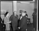 Sir Miles Thomas, Chairman of British Overseas Airways Corporation, and his wife (on left) socialising with an unidentified guest (in pinstripe suit) at a reception held in his honour at the Trans Tasman Hotel [Auckland?]