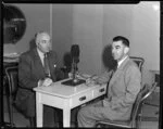 British Overseas Airways Corporation Chairman Sir Miles Thomas and photographer Leo Lemuel White (left to right) with a large microphone between them, location unknown