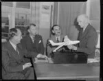 Tasman Group, executives (left to right), Captain Brownjohn, Mr F Larson, Captain Clarke and Mr G B Bolt, with a model aeroplane