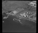 Unidentified factories, Carbine Road industrial area, Mt Wellington, Auckland, featuring commercial jetties on the Tamaki River