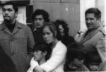 Family watching Vietnam War soldiers marching